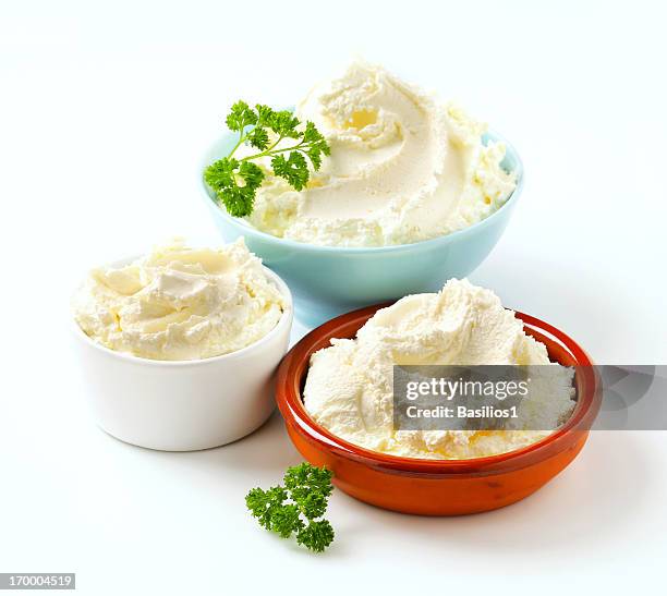 cream cheese in various bowls - cream cheese stock pictures, royalty-free photos & images