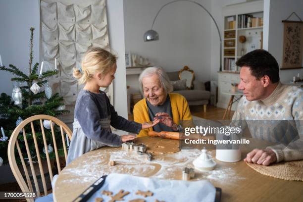 multi generation family baking christmas cookies at home - season 6 stock-fotos und bilder