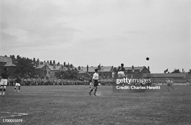 Nigerian player heading the ball during a match between Marine A.F.C. And the Nigeria national football team at Rossett Park, Crosby, Merseyside,...