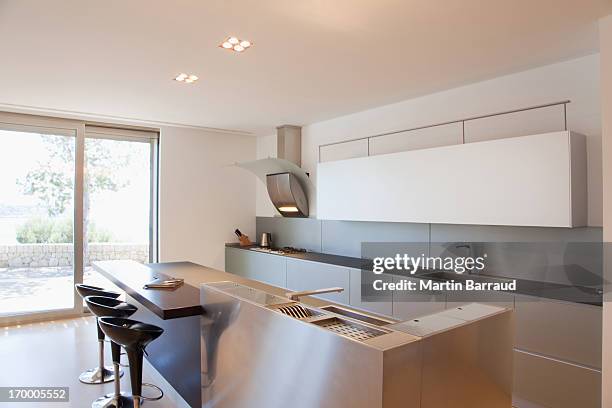 islands and stools in modern kitchen - kitchen stool stock pictures, royalty-free photos & images