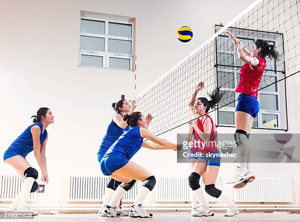 teenage girl team playing volleyball. - volleybal stockfoto's en -beelden