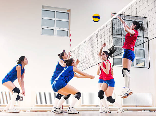 teenage girl team playing volleyball. - girls volleyball stock pictures, royalty-free photos & images