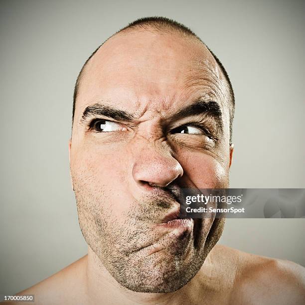 man grimacing - at a glance stockfoto's en -beelden