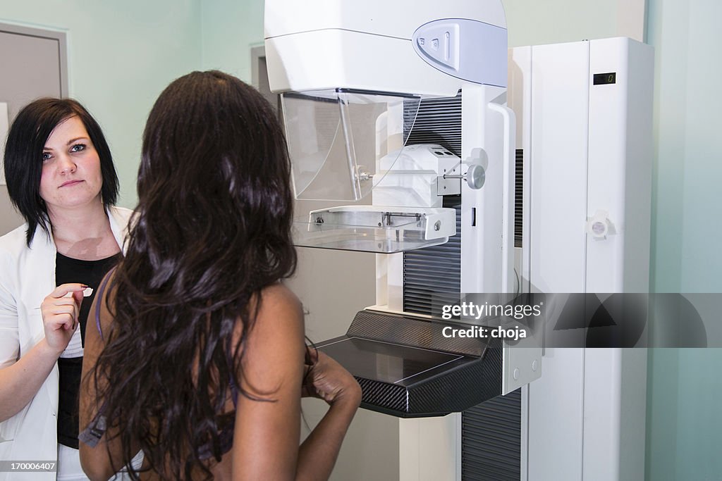 Nurse with young  black women having a mammography