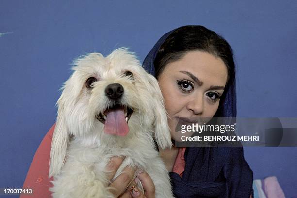 Iranian Media poses for a picture with her Terrier dog, Shiny in her...  News Photo - Getty Images