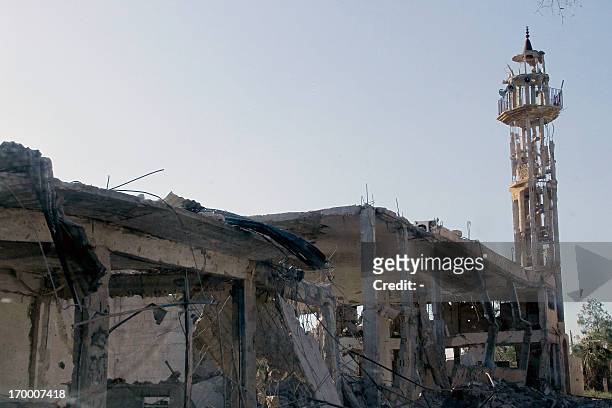 Picture taken on June 5, 2013 shows a building left in ruins in Qusayr in Syria's central Homs province, after government forces seized total control...