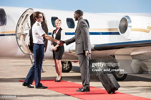 corporate pilot greeting business passenger - leer jet bildbanksfoton och bilder