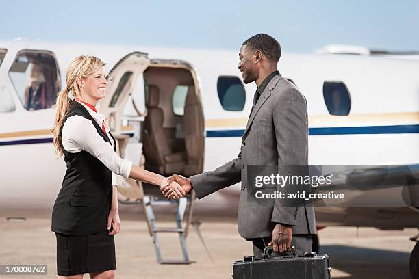 flight stewardess greeting business passenger - leer jet stock pictures, royalty-free photos & images