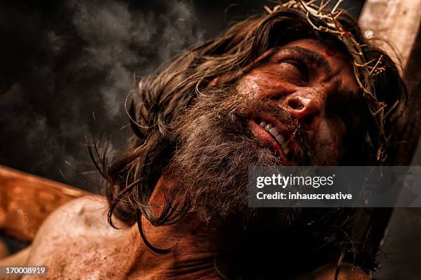 jesus christ on cross in pain - crucifixion stock pictures, royalty-free photos & images