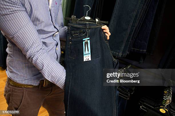 Price tag sits on a pair of ladies straight cut George branded denim jeans, manufactured in Bangladesh for the Asda supermarket chain, the U.K....