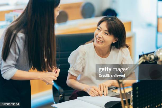 inside the office, an employee is having a conversation with a coworker to inquire about work-related matters. - matters stock pictures, royalty-free photos & images