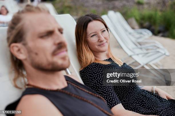couple relaxing in deckchairs - mid adult couple stock pictures, royalty-free photos & images