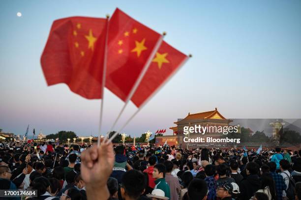 Visitors gather for the flag raising ceremony at Tiananmen Square to mark National Day in Beijing, China on Sunday, Oct. 1, 2023. President Xi...