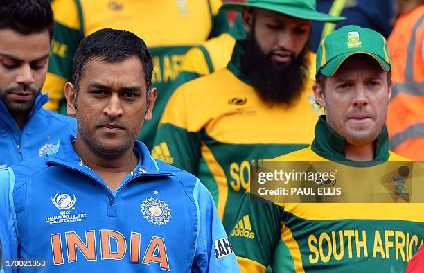 India's Mahendra Sing Dhoni and South Africa's AB de Villiers lead their teams out for the start of the 2013 ICC Champions Trophy cricket match...