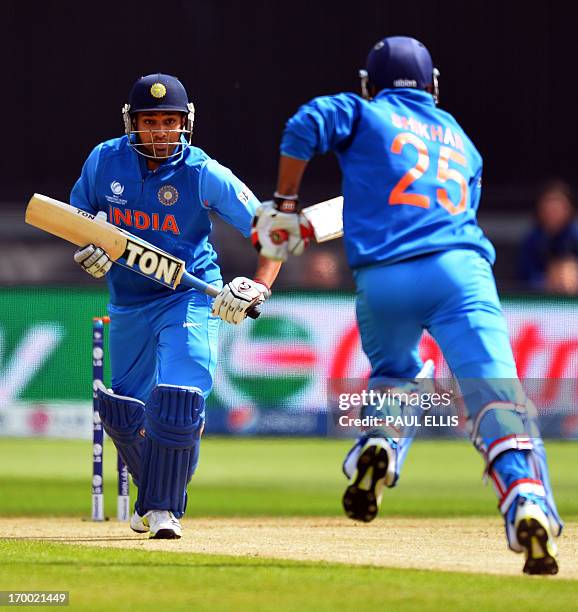 India's Rohit Sharma and Shikhar Dhawan run during the 2013 ICC Champions Trophy cricket match between India and South Africa at The Cardiff Wales...