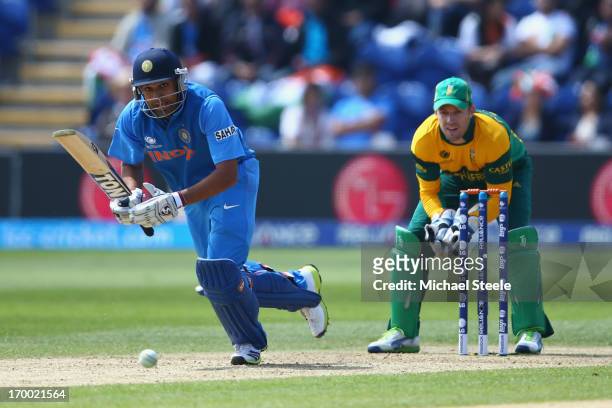 Rohit Sharma of India sets off for a single as wicketkeeper AB de Villiers of South Africa looks on during the Group B ICC Champions Trophy match...