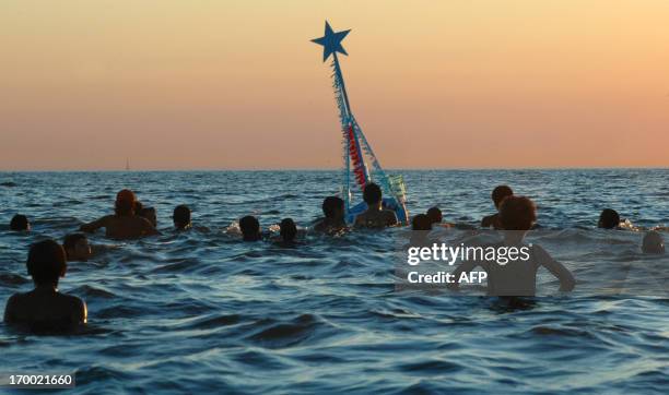 Peope give offerings to Iemanja, the Goddess of the Sea of the Afro-American religion Umbanda, 02 February 2007 at a beach in Montevideo. Thousands...