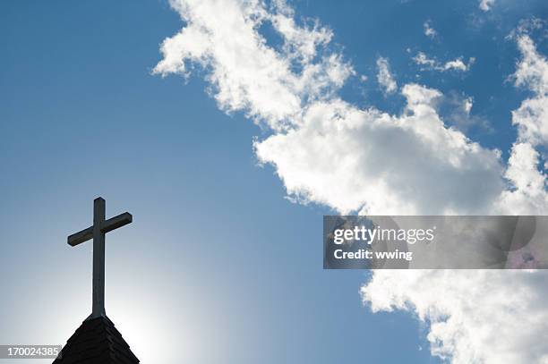 sunlit cross and steeple - evangelicalism stock pictures, royalty-free photos & images