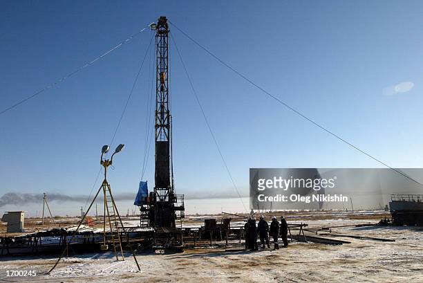 Workers service an oil well owned by the Canadian oil company Hurricane Kumkol Munai December 20, 2002 about 200 km north of Kyzylorda, Kazakhstan....