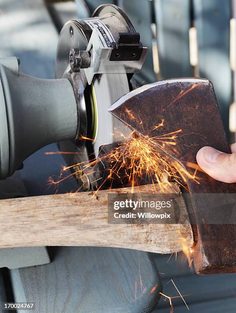 sharpening an old axe - sharpening stock pictures, royalty-free photos & images