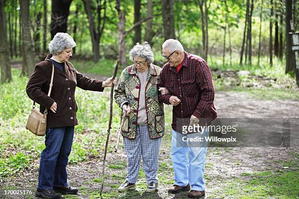 daughter and senior parents on nature trail - grandma cane stock pictures, royalty-free photos & images