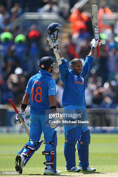 Shikhar Dhawan of India celebrates reaching his century alongside Virat Kohli during the Group B ICC Champions Trophy match between India and South...