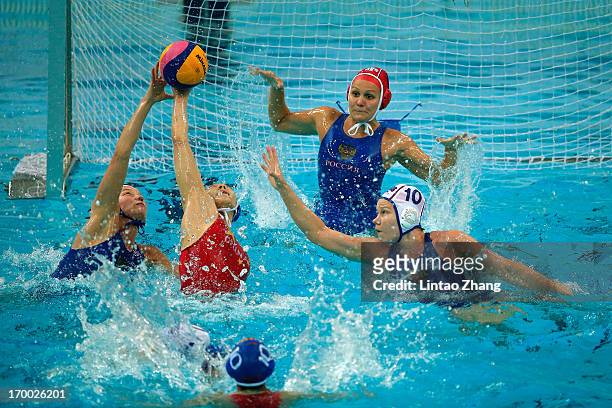 Zhang Cong of China challenges Ivanova Evgeniya and Beliaeva Olga of Russia during the Women's Water Polo Gold Medal match between the China and...