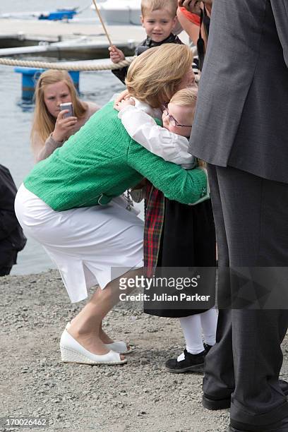 Queen Sonja of Norway is greeted by 4 year old Eyla Cyone on her arrival at the quayside in Afjord,on the last day of a three day visit to the county...