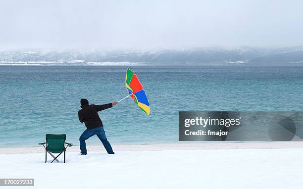 windy beach - beach umbrella isolated stockfoto's en -beelden