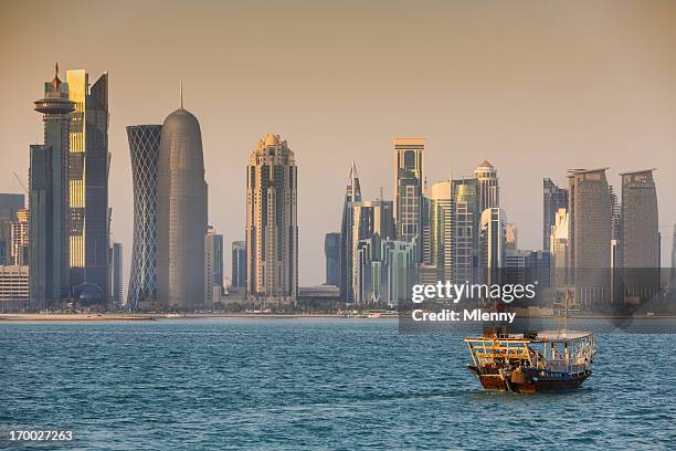 dhow cruising to modern doha skyline, qatar - dhow qatar stock pictures, royalty-free photos & images