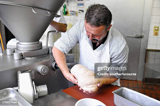 butcher filling baking dish with meat dough traditional swiss leberkaese - leberkäse stock pictures, royalty-free photos & images