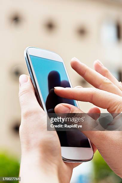 feminine hands pinching to zoom on smart phone - pinching stock pictures, royalty-free photos & images