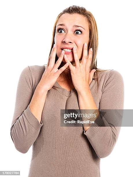 beautiful, wide eyed, terrified young woman, hands to face - looking around on white background stock pictures, royalty-free photos & images