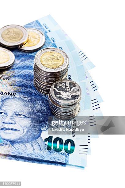 silver coins hold down new south african banknotes featuring mandela - south african currency stock pictures, royalty-free photos & images