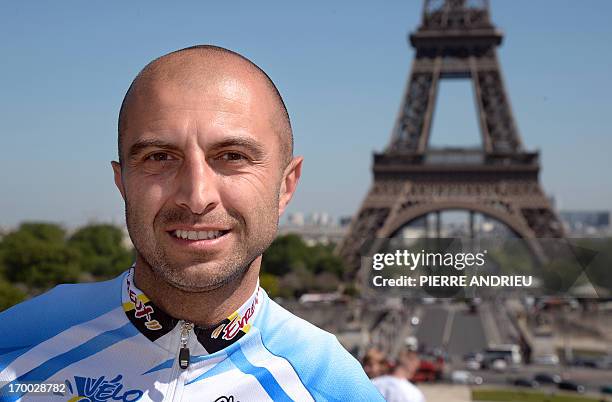 French cyclist Pierre-Michael Micaletti poses on June 5, 2013 in front of the Eiffel tower in Paris. While some cycle the Paris-Nice route in seven...