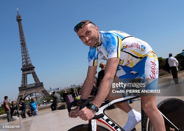 French cyclist Pierre-Michael Micaletti poses on June 5, 2013 in front of the Eiffel tower in Paris. While some cycle the Paris-Nice route in seven...