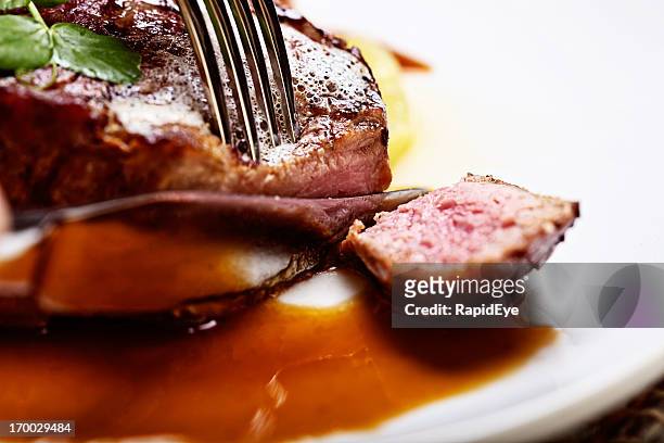 knife and fork slice into rare grilled steak - beefsteak 2013 stock pictures, royalty-free photos & images