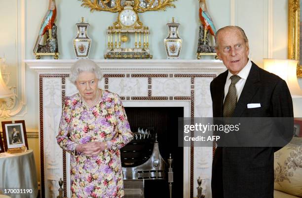 Britain's Queen Elizabeth II waits with Prince Philip, Duke of Edinburgh before presented him with his medal and investing him with New Zealand's...