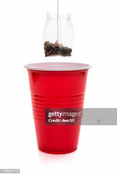 teabag being lifted from cup of tea - herbal tea bag stock pictures, royalty-free photos & images