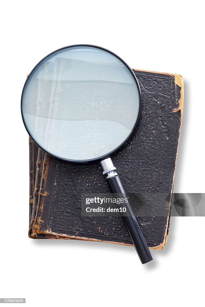 Magnifying glass on antique book