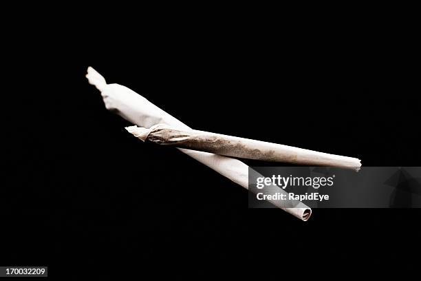two reefers on a stark black background - marijuana joint stock pictures, royalty-free photos & images