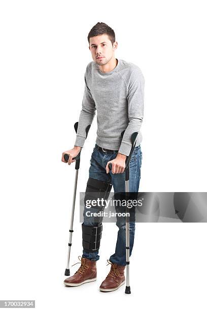 young handsome man with broken leg - man crutches stock pictures, royalty-free photos & images