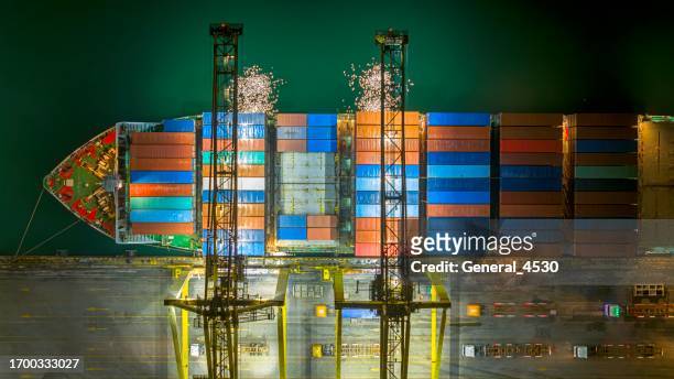 aerial view ontainers yard in port congestion with ship vessels are loading and discharging operations of the transportation in international port at night time. - container shipping operations at port of hamburg stock pictures, royalty-free photos & images