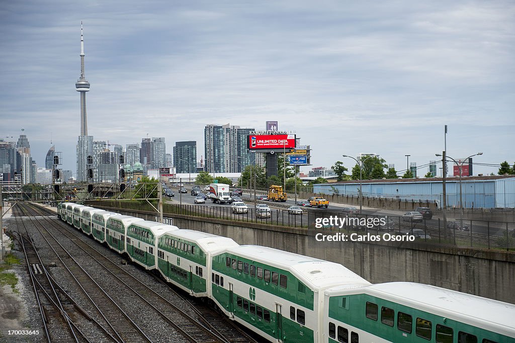 GO Train And The Gardiner Expressway With CN Tower In Background