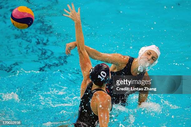 Keszthelyi Rita of Hungary challenges Kelly Rulon of United States during the Women's Water Polo Gold Medal match between the United States and...