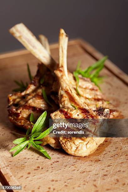 appetizing grilled cutlets on a wooden cutting board. - kotlett med ben bildbanksfoton och bilder
