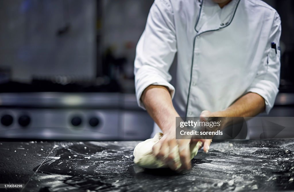 Chef kneading dough