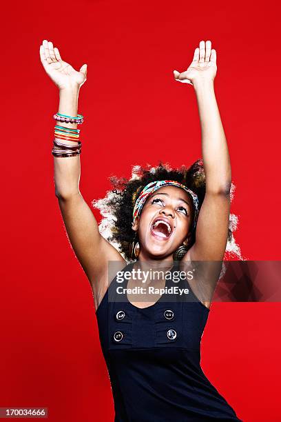 gospel singing or praise dancing, young afro-haired woman is ecstatic - gospel stockfoto's en -beelden