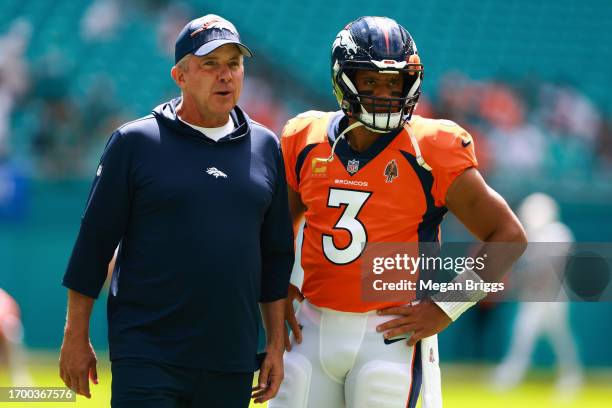 Head coach Sean Payton of the Denver Broncos talks to Russell Wilson of the Denver Broncos prior to a game against the Miami Dolphins at Hard Rock...