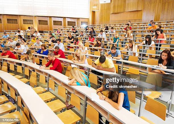 large group of students doing exam. - community theater stock pictures, royalty-free photos & images